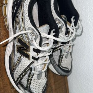 New Balance White and Black Sneakers with Gold Accents